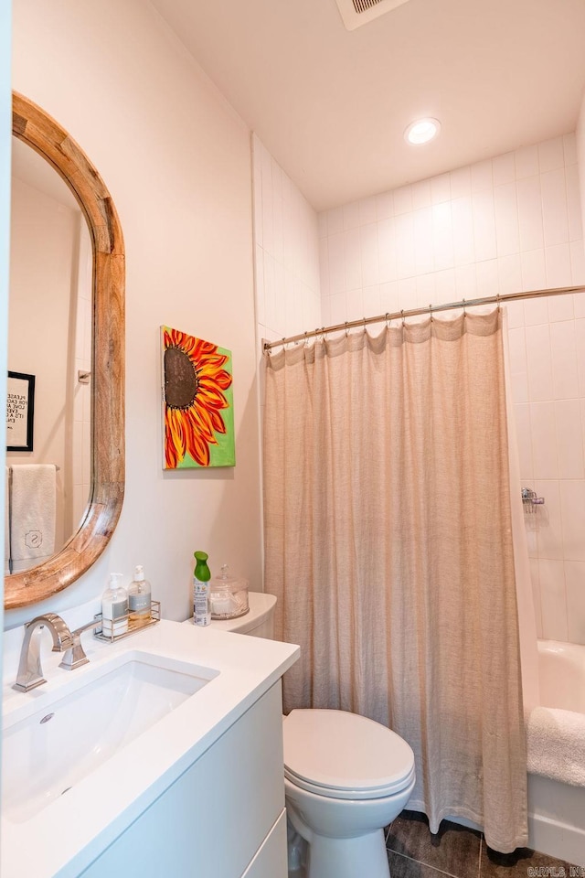 full bathroom with vanity, shower / tub combo, toilet, and tile patterned floors