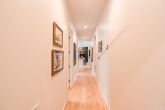 corridor with light wood-type flooring