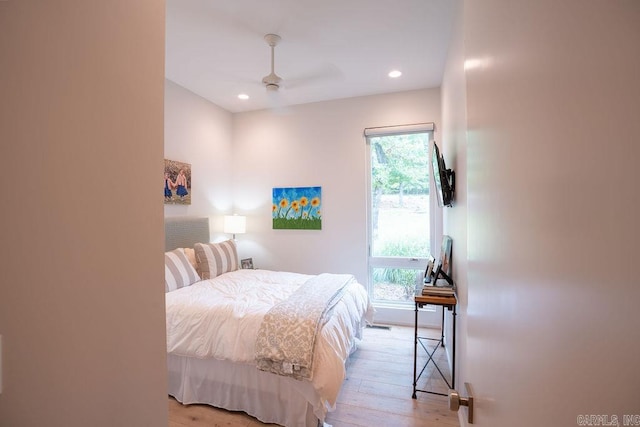 bedroom with light hardwood / wood-style flooring and ceiling fan