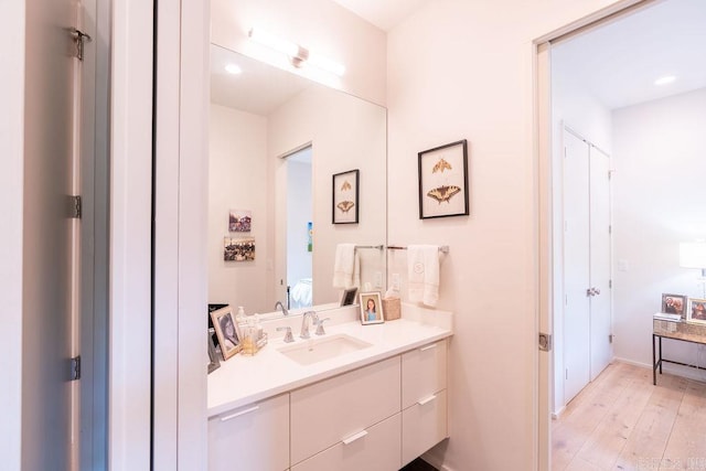 bathroom with vanity and hardwood / wood-style flooring