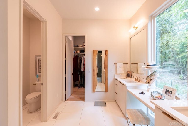 bathroom with tile patterned flooring, vanity, and toilet