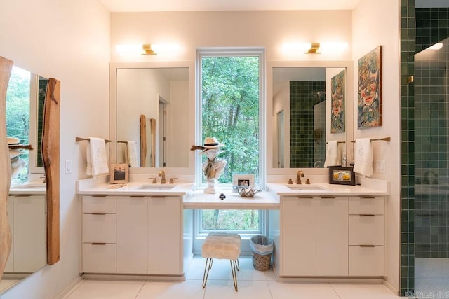 bathroom featuring tile patterned floors, vanity, and tiled shower