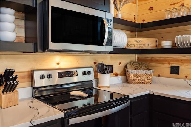 kitchen featuring light stone countertops and appliances with stainless steel finishes