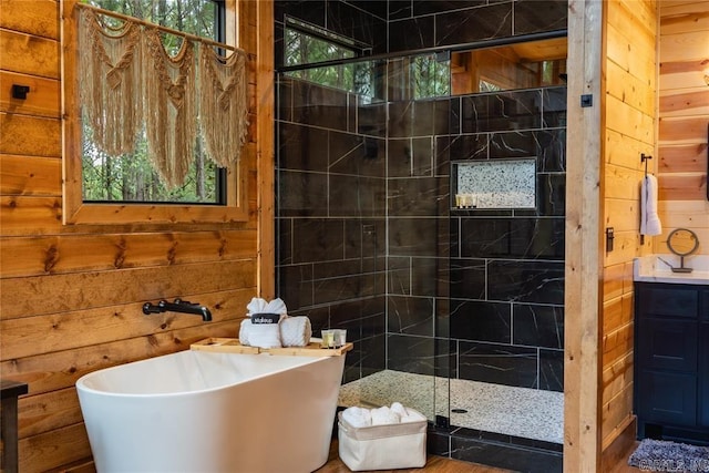 bathroom featuring wooden walls, vanity, and separate shower and tub