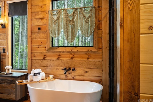 bathroom with a bathing tub and wood walls