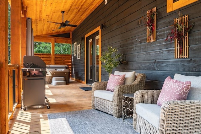 sunroom featuring wood ceiling, lofted ceiling, and ceiling fan