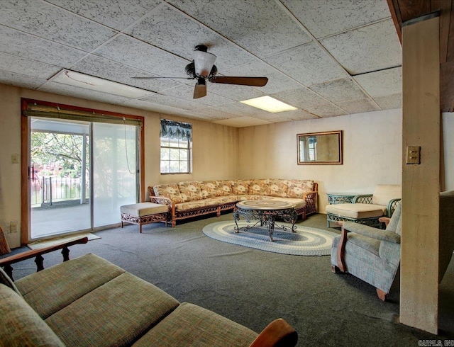 carpeted living room featuring ceiling fan, plenty of natural light, and a paneled ceiling