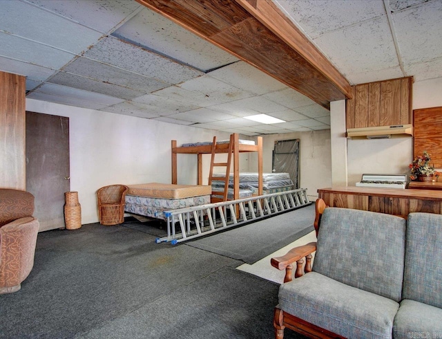 carpeted bedroom featuring a paneled ceiling