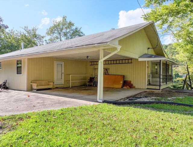 back of house with a yard and a patio