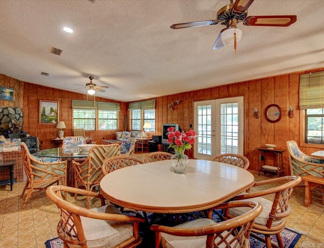 dining space featuring a textured ceiling, ceiling fan, and a wealth of natural light