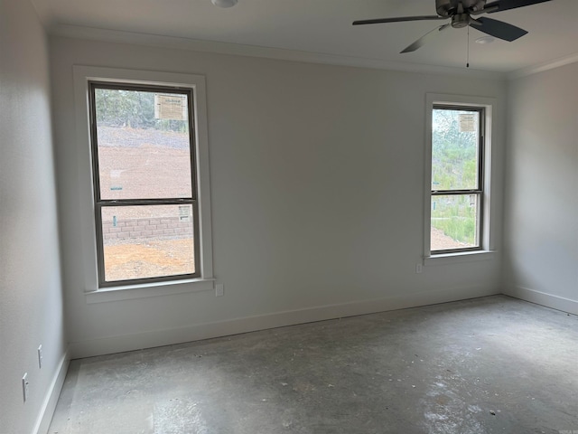 spare room featuring crown molding, a healthy amount of sunlight, and ceiling fan