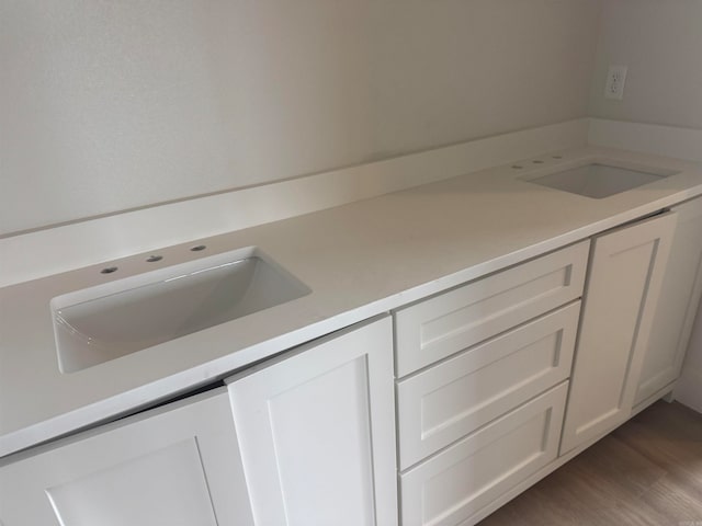 bathroom featuring vanity and hardwood / wood-style flooring