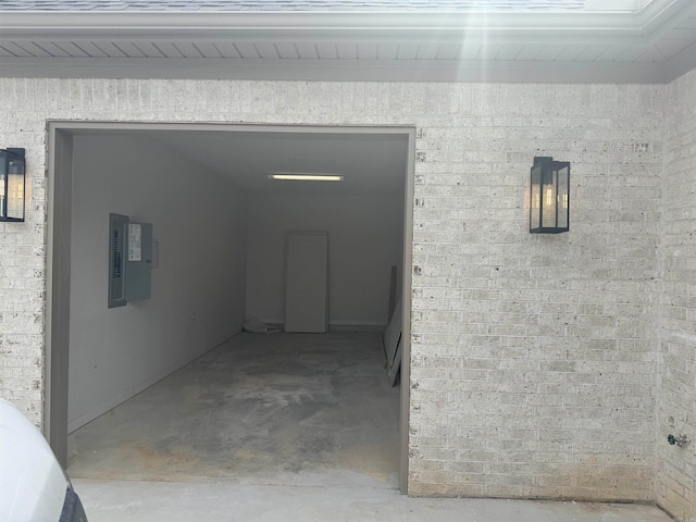 interior space featuring electric panel and concrete flooring