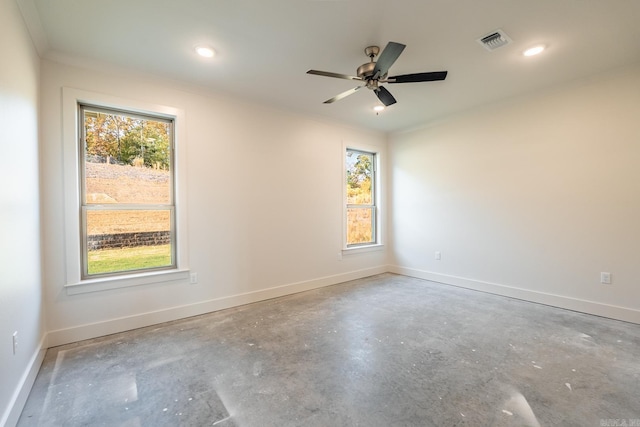 unfurnished room with crown molding, concrete floors, and ceiling fan