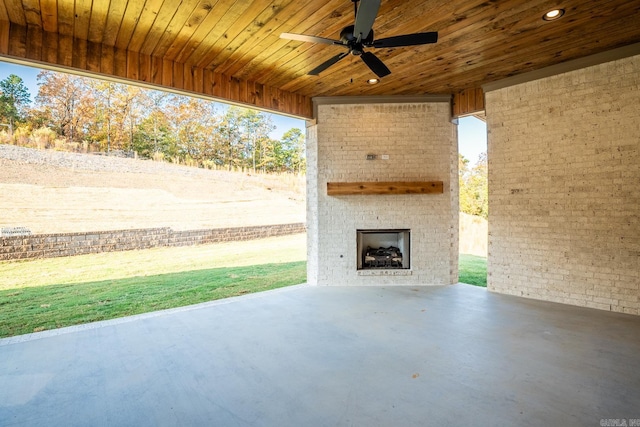 view of patio featuring an outdoor brick fireplace and ceiling fan