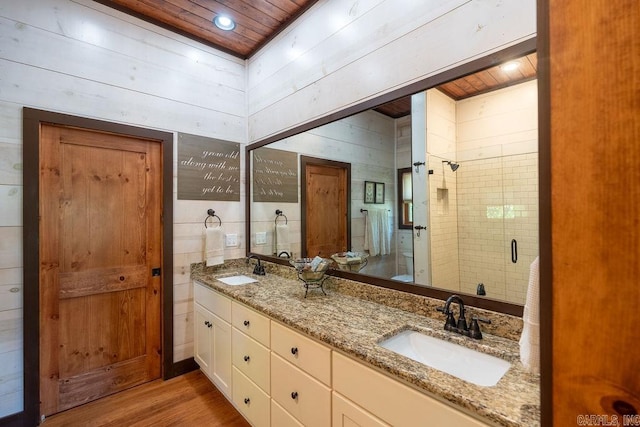 bathroom with vanity, wood ceiling, wood walls, an enclosed shower, and wood-type flooring