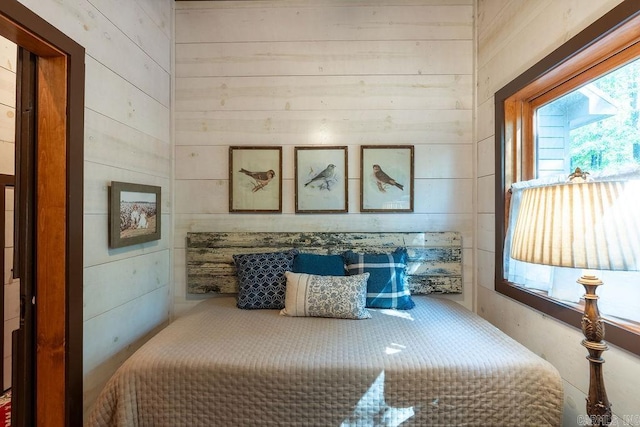 bedroom featuring wood walls