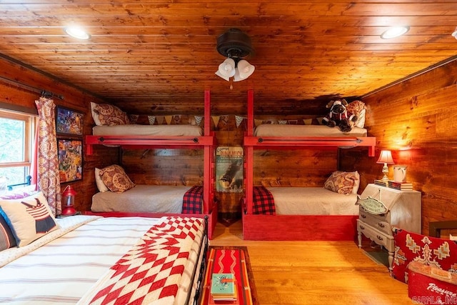 bedroom featuring wooden ceiling, light hardwood / wood-style floors, and wood walls