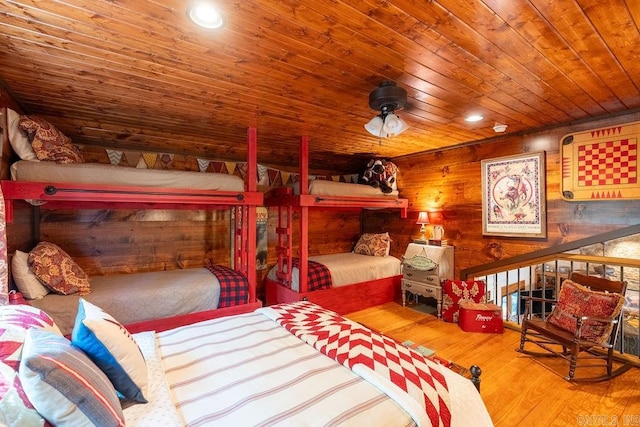 bedroom featuring wood ceiling, wood walls, and hardwood / wood-style floors