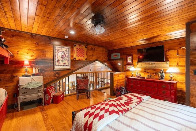 bedroom with wood-type flooring, wood ceiling, and wood walls