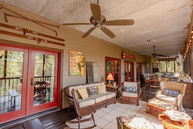 sunroom / solarium with ceiling fan and french doors