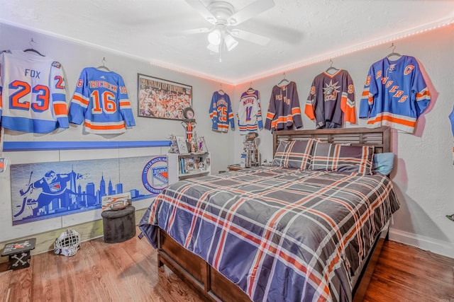 bedroom with ceiling fan and hardwood / wood-style flooring