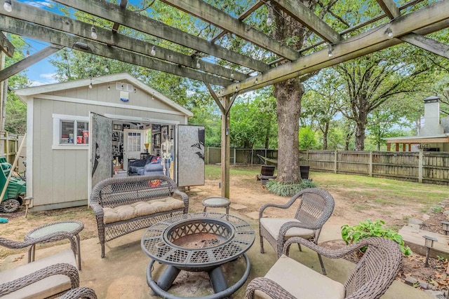 view of patio / terrace featuring an outdoor structure, a pergola, and an outdoor fire pit