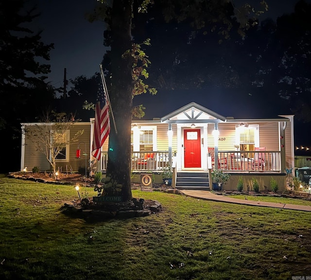 view of front of home featuring a lawn and covered porch