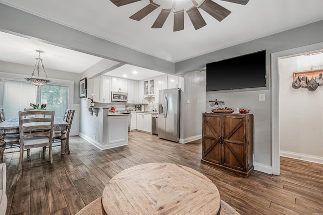 interior space with light hardwood / wood-style floors, sink, and ceiling fan