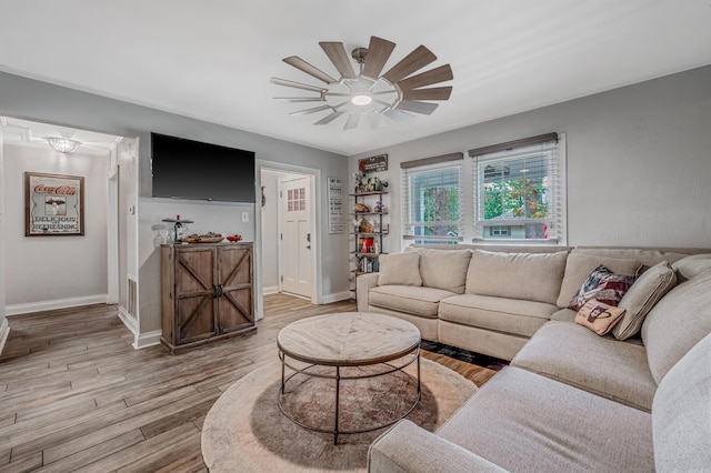 living room featuring light hardwood / wood-style floors and ceiling fan