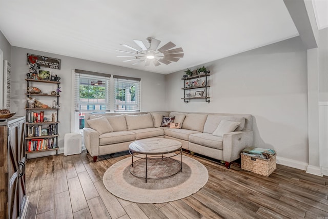 living room with wood-type flooring and ceiling fan