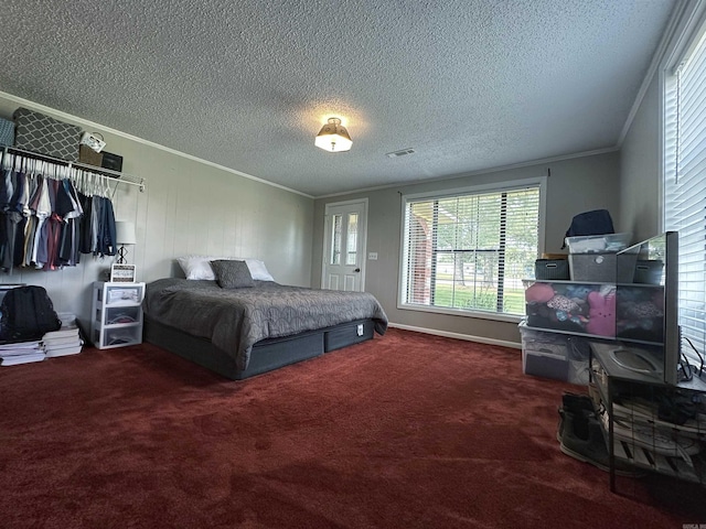 bedroom featuring carpet floors, a textured ceiling, and ornamental molding