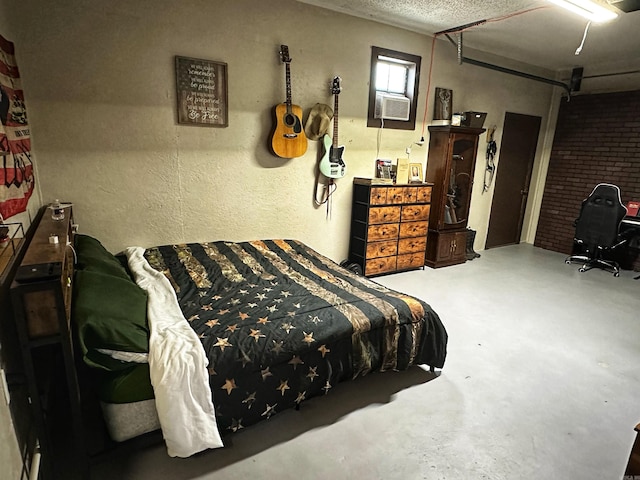 bedroom featuring a textured ceiling and concrete floors