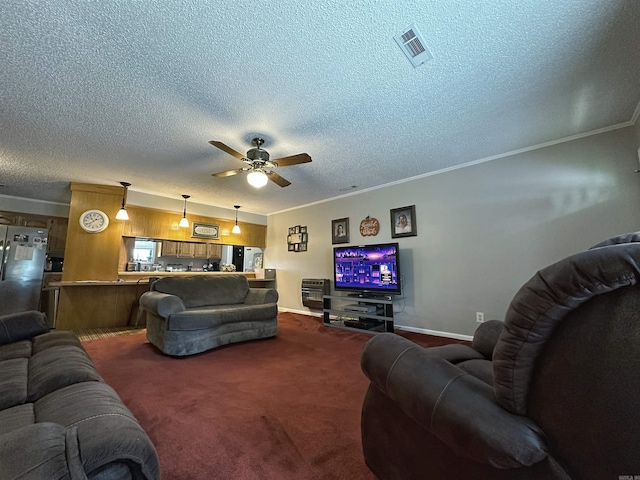 carpeted living room with ceiling fan, crown molding, and a textured ceiling