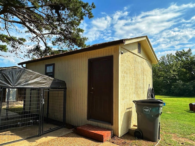 view of outbuilding featuring a lawn