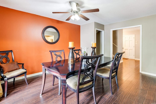 dining room with ceiling fan and dark hardwood / wood-style floors