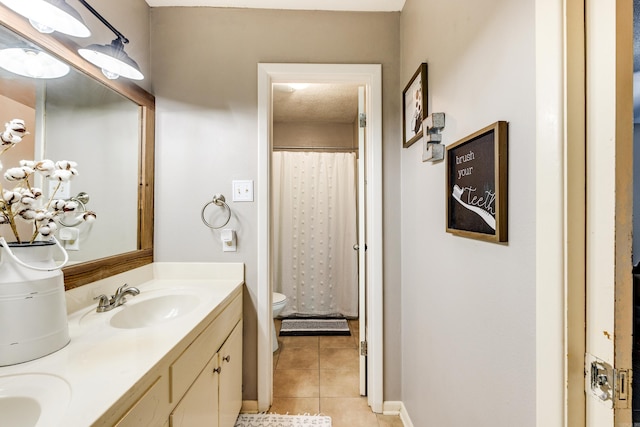 bathroom featuring tile patterned flooring, vanity, toilet, and a shower with curtain