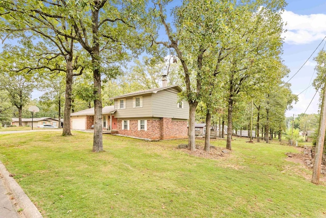 view of side of property featuring a garage and a lawn