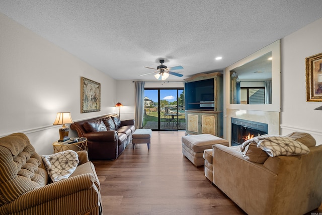 5371 Central Ave Unit 1B, Hot Springs, AR 72210 - living area featuring a textured ceiling, a fireplace, wood finished floors, a ceiling fan, and recessed lighting