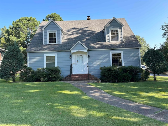 cape cod house with a front yard