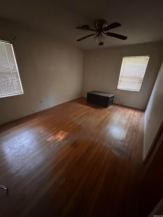 spare room with ceiling fan and hardwood / wood-style flooring