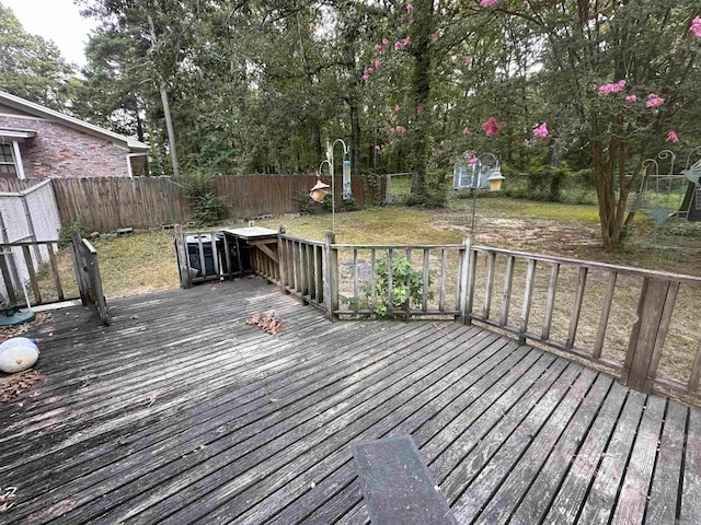 wooden deck with a yard and a shed