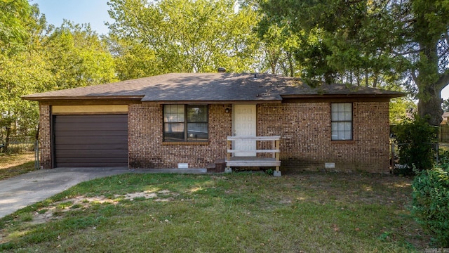 single story home featuring a front lawn and a garage