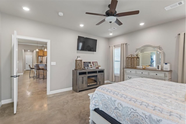 bedroom featuring ceiling fan and stainless steel fridge