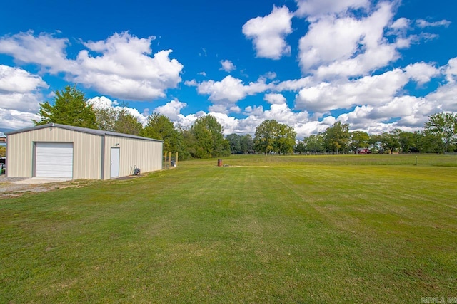 view of yard featuring a garage and an outdoor structure