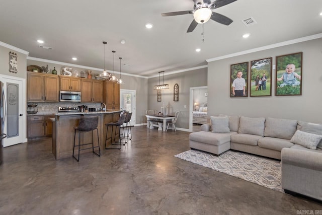 living room with ceiling fan and crown molding