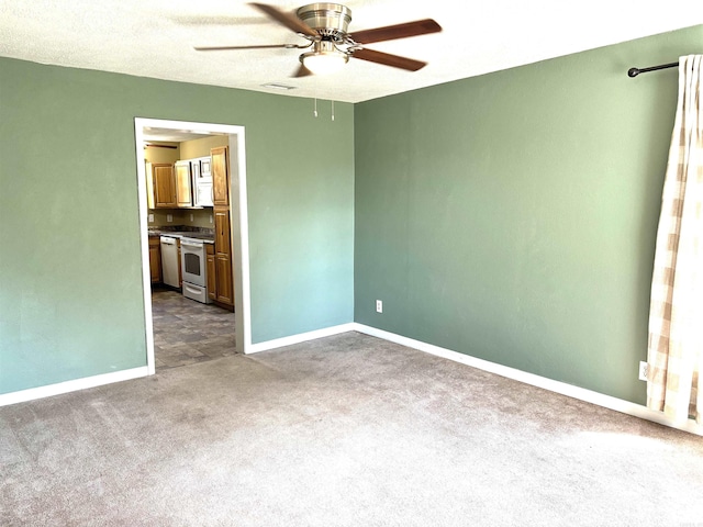 carpeted empty room featuring a textured ceiling and ceiling fan