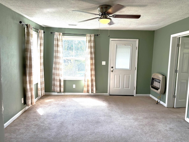 entryway featuring light carpet, heating unit, ceiling fan, and a textured ceiling