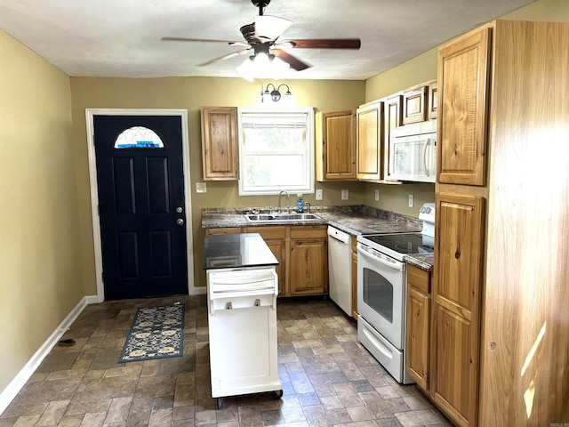 kitchen featuring white appliances, sink, ceiling fan, and light brown cabinets