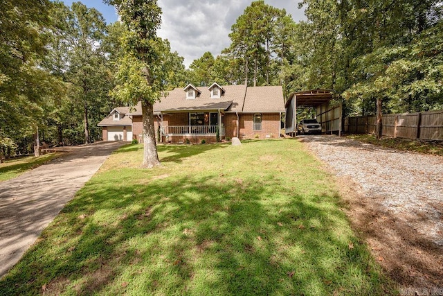 view of front of home with a front lawn, a carport, and a porch